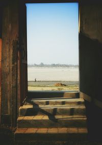 Scenic view of sea against clear sky seen through window