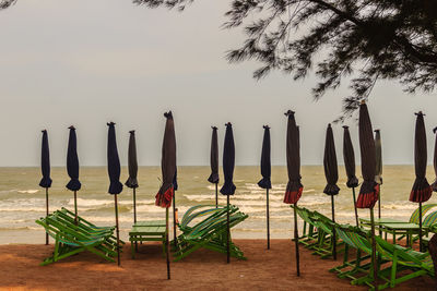 Panoramic shot of chairs on beach against sky