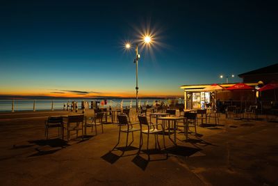 Scenic view of beach against clear sky at sunset