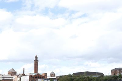 View of cityscape against cloudy sky