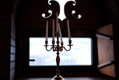 Low angle view of illuminated lamp hanging at home