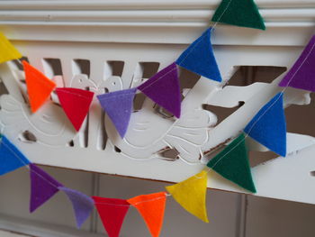 Close-up of multi colored paper flags on table