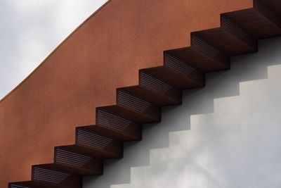 Low angle view of spiral staircase against wall