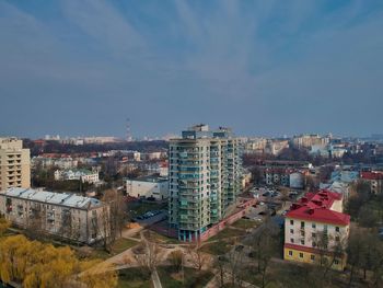 High angle view of buildings against blue sky