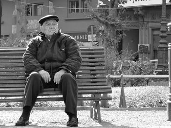 Man sitting on bench in park