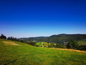 Scenic view of landscape against clear blue sky