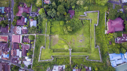 Aerial view of grass field amidst houses