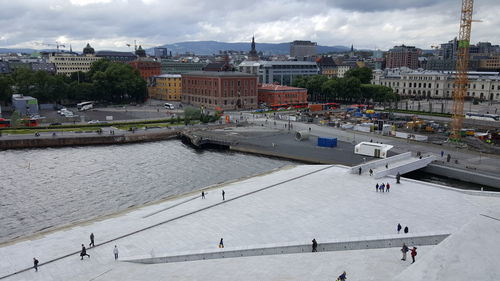 High angle view of people in city against sky