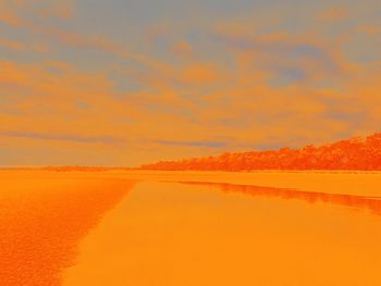 Scenic view of sea against orange sky