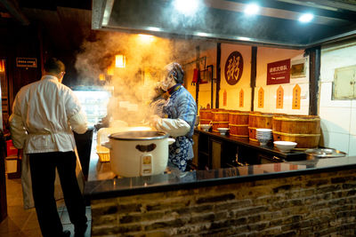 People working in kitchen at restaurant