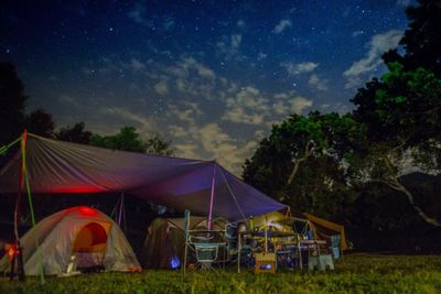 Tent on field against sky at night