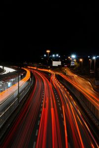 High angle view of light trails on highway at night