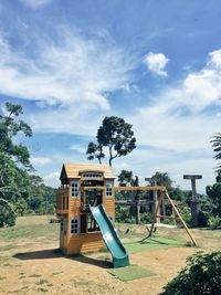 Playground in park against sky