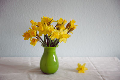 Yellow flowers in vase on table