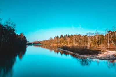 Scenic view of lake against blue sky