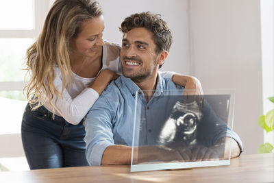 Young couple sitting at home