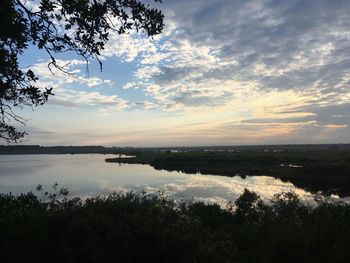 Scenic view of lake against sky during sunset