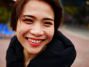 Close-up of smiling beautiful woman with short hair