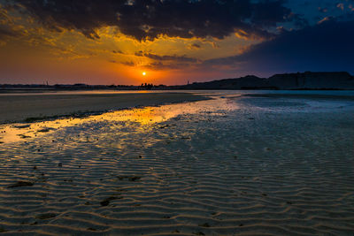 Scenic view of beach against sky during sunset