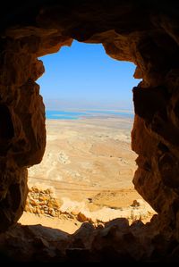 Scenic view of masada seen through cave window