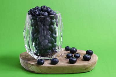 Close-up of fruits on table against blue background