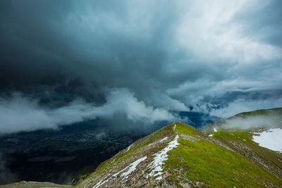 Scenic view of mountain against cloudy sky