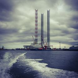 View of harbor against cloudy sky