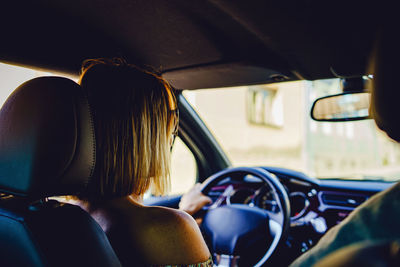 Rear view of people sitting in car