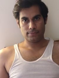 Close-up portrait of smiling young man at home