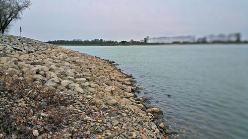 Scenic view of pebbles in sea