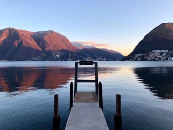 Pier over lake against clear sky