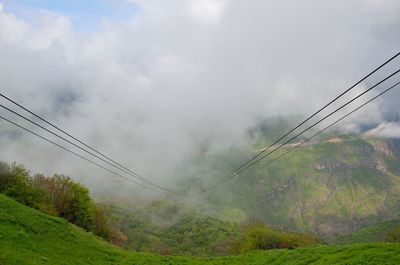 Low angle view of cables against sky