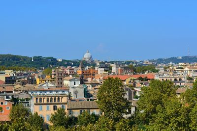 View of cityscape against blue sky