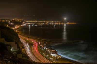 High angle view of illuminated bridge over river in city at night