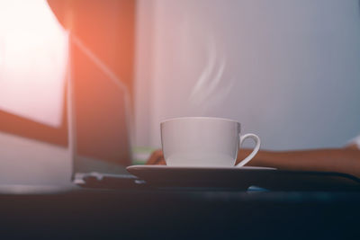 Close-up of coffee cup on table