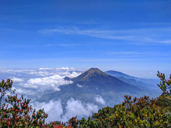 Scenic view of mountains against blue sky