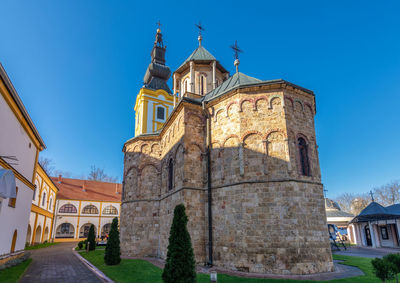 Low angle view of historic building against clear blue sky