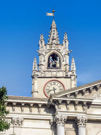 Low angle view of clock tower against sky