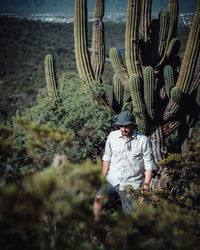Full length of young man on cactus