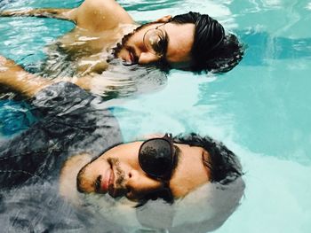 Portrait of friends in swimming pool