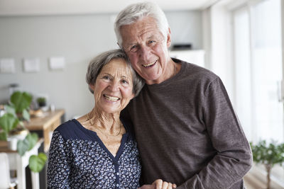 Portrait of happy senior couple at home