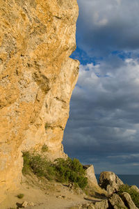 Low angle view of rock formation against sky