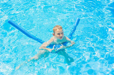 Portrait of boy swimming in pool