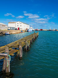 Scenic view of sea and houses against sky