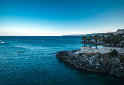 Scenic view of sea against clear blue sky