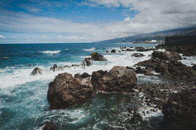 Scenic view of sea against cloudy sky