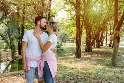 Happy young couple standing on land