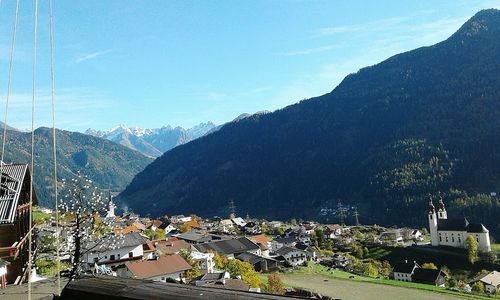 High angle view of town by mountains against sky