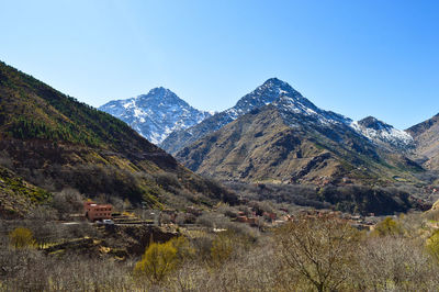 Scenic view of mountains against clear blue sky