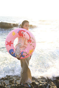 Full length of girl at beach against sky